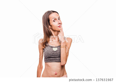 Woman with anorexia pointing at her face with concern 137631987