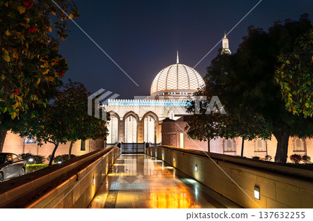 Beautiful night view of the illuminated dome and architecture of the Sultan Qaboos Grand Mosque in Muscat, Oman. Beautiful night view of the illuminated dome and architecture of the Sultan Qaboos Grand Mosque in Muscat, Oman. 137632255