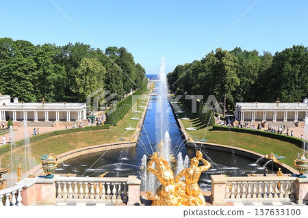 Russia, St. Petersburg, Peterhof, July 12, 2021. The photo shows the fountain of the Grand Cascade in the Lower Park of the State Museum-Reserve "Peterhof" and people walking in the park, selective Russia, St. Petersburg, Peterhof, July 12, 2021. The photo shows the fountain of the Grand Cascade in the Lower Park of the State Museum-Reserve "Peterhof" and people walking in the park, selective 137633100