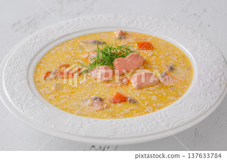 Finnish creamy salmon soup lohikeitto with vegetables served in elegant white plate Finnish creamy salmon soup lohikeitto with vegetables served in elegant white plate 137633784