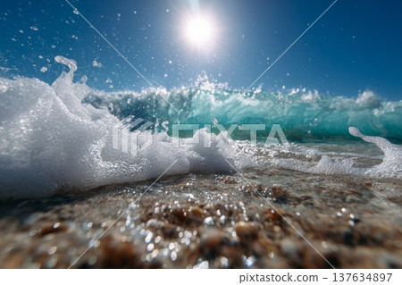 Majestic wave crashing onto golden beach under a radiant sun, creating a picturesque seaside atmosphere. 137634897