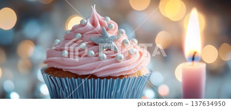 Delightful pink frosted cupcake adorned with a shimmering star decoration, perfect for celebrations and sweet treats. 137634950