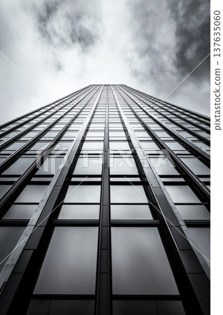 Majestic skyscraper reaching for the clouds against a vibrant blue sky filled with fluffy white clouds. Majestic skyscraper reaching for the clouds against a vibrant blue sky filled with fluffy white clouds. 137635060