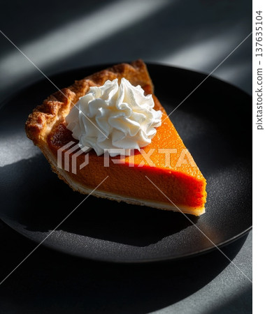 Delicious slice of pumpkin pie topped with fluffy whipped cream on a sleek black plate, perfect for autumn desserts. Delicious slice of pumpkin pie topped with fluffy whipped cream on a sleek black plate, perfect for autumn desserts. 137635104