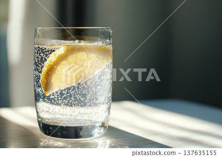 Refreshing Glass of Water with a Vibrant Lemon Slice for a Healthy Hydration Experience Refreshing Glass of Water with a Vibrant Lemon Slice for a Healthy Hydration Experience 137635155