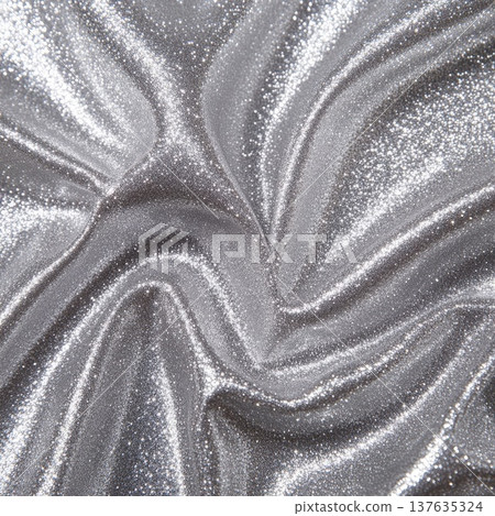 Elegant Silver Fabric Showcasing a Shiny Texture Under Soft Ambient Lighting for Textural Visual Inspiration 137635324