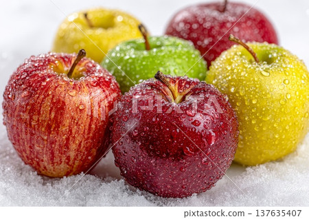 Beautiful red, yellow and green apples on white snow Beautiful red, yellow and green apples on white snow 137635407