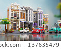 A city with houses, streets, and cars stylized like Lego bricks 137635479