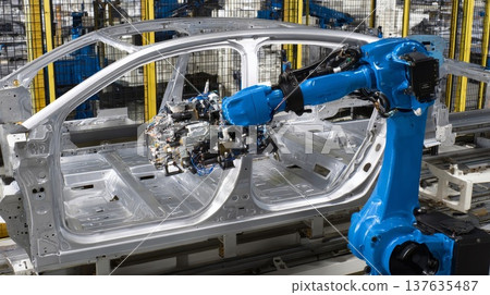 An industrial robot welds a car frame on a modern automated assembly line in an automotive factory. 137635487