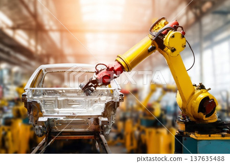 An industrial robot welds a car frame on a modern automated assembly line in an automotive factory. 137635488