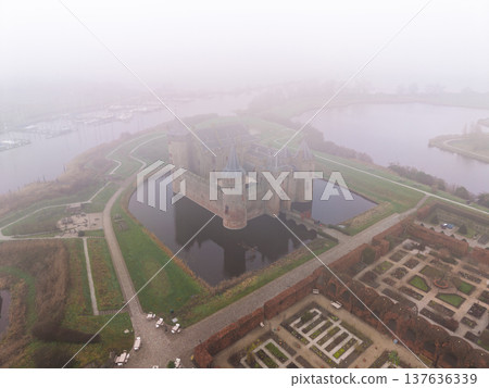 This is a stunning aerial shot of Muiderslot Castle. The heavy fog adds a fantastic moody, cinematic quality that stock buyers love. This is a stunning aerial shot of Muiderslot Castle. The heavy fog adds a fantastic moody, cinematic quality that stock buyers love. 137636339