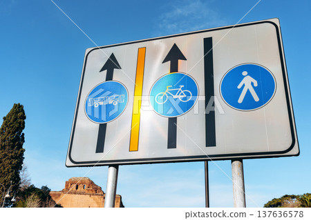 Traffic sign showing bus, bicycle, and pedestrian paths at a busy intersection in the city Traffic sign showing bus, bicycle, and pedestrian paths at a busy intersection in the city 137636578