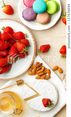 Fresh strawberries and sweet treats on a table during a sunny day Fresh strawberries and sweet treats on a table during a sunny day 137636694