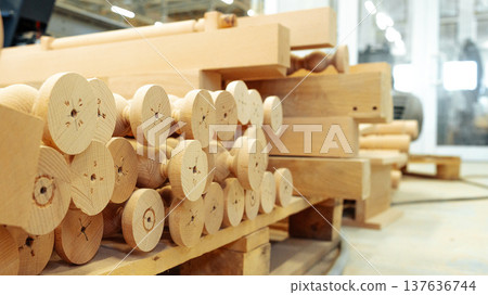 Wooden pieces stored in a workshop near tools and machinery for future projects Wooden pieces stored in a workshop near tools and machinery for future projects 137636744