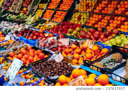 Fresh fruits and vegetables for sale at a market during the day in a busy location Fresh fruits and vegetables for sale at a market during the day in a busy location 137637057