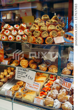 Bakery display with various pastries and desserts in a busy market Bakery display with various pastries and desserts in a busy market 137637083