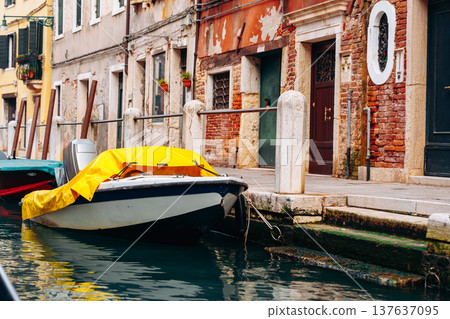 Boat moored by old buildings near canal in Venice during daylight hours 137637095