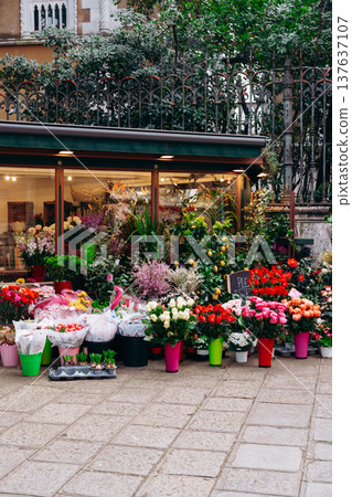 Flower shop displays colorful bouquets in city center during midday Flower shop displays colorful bouquets in city center during midday 137637107