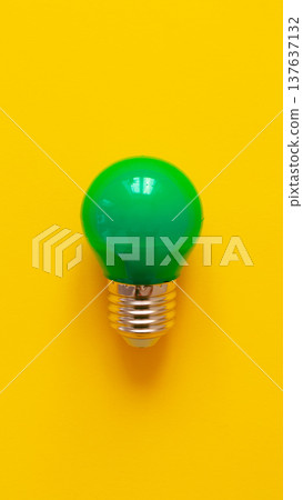 Bright green light bulb on yellow background for creative design and innovative ideas Bright green light bulb on yellow background for creative design and innovative ideas 137637132