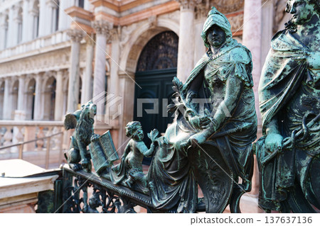 Bronze statues on a railing near an old building in Venice during daylight hours Bronze statues on a railing near an old building in Venice during daylight hours 137637136