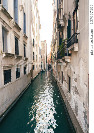 Narrow waterway between buildings in Venice during daytime in autumn season Narrow waterway between buildings in Venice during daytime in autumn season 137637193