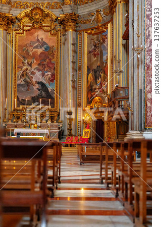 Visitors view art and architecture inside a historic church during daylight hours Visitors view art and architecture inside a historic church during daylight hours 137637253