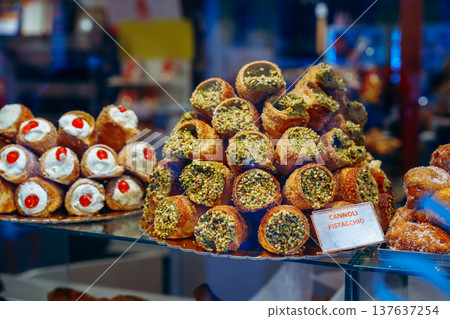Sweet display of cannoli and pastries in a bakery during the afternoon in Italy Sweet display of cannoli and pastries in a bakery during the afternoon in Italy 137637254