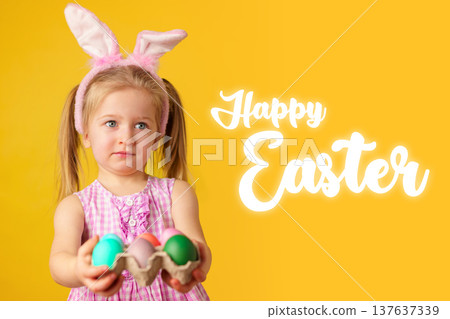 Child holds colorful eggs for Easter celebration with yellow background and bunny ears Child holds colorful eggs for Easter celebration with yellow background and bunny ears 137637339