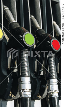 Different fuel dispensers lined up at a gas station showing various colors and types Different fuel dispensers lined up at a gas station showing various colors and types 137637417