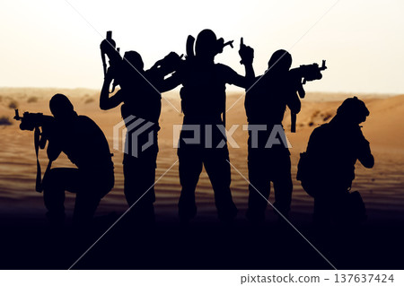 Silhouettes of soldiers prepare for conflict in a desert setting during Iran USA tensions 137637424