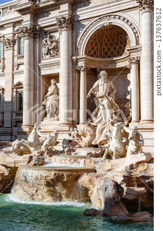 Trevi Fountain in Rome with sculptures and flowing water on a sunny day Trevi Fountain in Rome with sculptures and flowing water on a sunny day 137637612