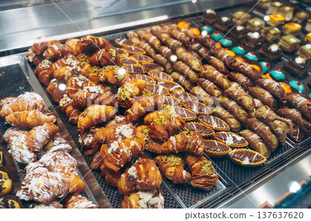 Bakery display of various pastries and sweets in a shop late in the day Bakery display of various pastries and sweets in a shop late in the day 137637620