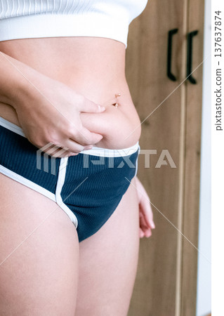 Female torso. Overweight abdomen detail. Real beauty concept Female torso. Overweight abdomen detail. Real beauty concept 137637874