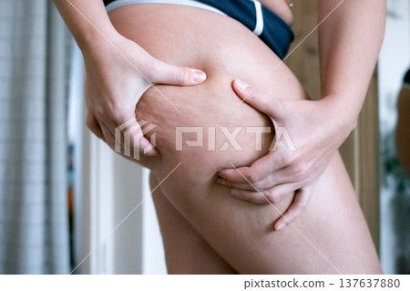 Woman weight check. Female examining torso fat indoors. Self car Woman weight check. Female examining torso fat indoors. Self car 137637880
