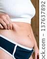 Woman overweight body. Female touching stomach near mirror. Weig 137637892