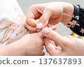 Child finger injury. Toddler receiving adhesive support outdoors. Family wellbeing concept. 137637893