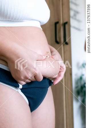 Adult woman. Unretouched body in underwear. Self image concept Adult woman. Unretouched body in underwear. Self image concept 137637896