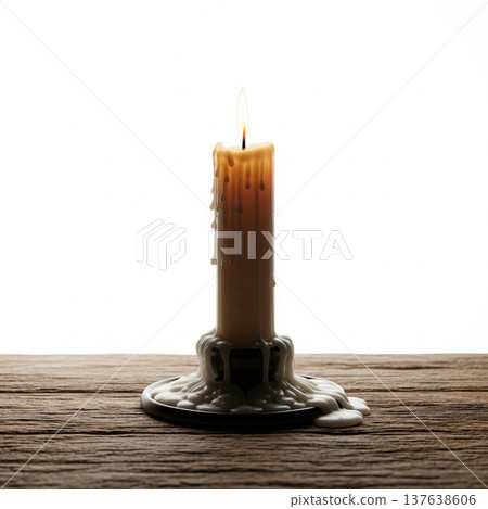 Lit Candle with Dripping Wax on Wooden Table Against White Background 137638606