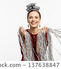 Smiling Woman Holding Silver Streamers Wearing Happy New Year Headband 137638847