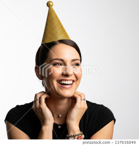 Laughing Woman in Black Shirt and Gold Party Hat on White Background 137638849