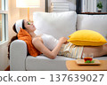 Beauty young asian woman relax on sofa with cucumber eye mask in living room at home. 137639027