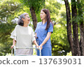 Asian female caregiver assistance senior patient with walker for physical rehabilitation and therapy. 137639031
