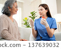 Asian woman nurse explaining medicine instruction to senior patient. 137639032