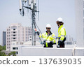 Technician team talking collaboration working on rooftop building. 137639035