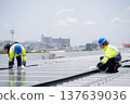 Caucasian worker team installing solar cell for sustainable energy power. 137639036