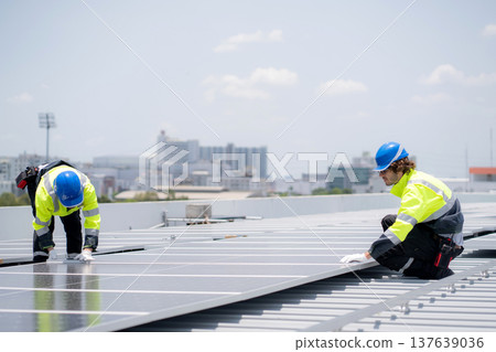 Caucasian worker team installing solar cell for sustainable energy power. 137639036