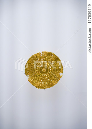 Isolated Ancient Round Gold Jewelry Artifact on White Background. High quality photo Isolated Ancient Round Gold Jewelry Artifact on White Background. High quality photo 137639349