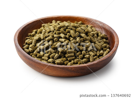 Rabbit food pellets in a wooden bowl on a white background Rabbit food pellets in a wooden bowl on a white background 137640692