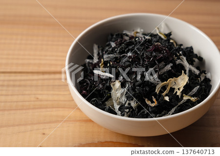 盛於白色盤子上的乾海藻沙拉，背景為木紋。 137640713
