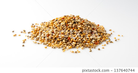 Mixed bird feed (seeds) placed against a white background. Mixed bird feed (seeds) placed against a white background. 137640744
